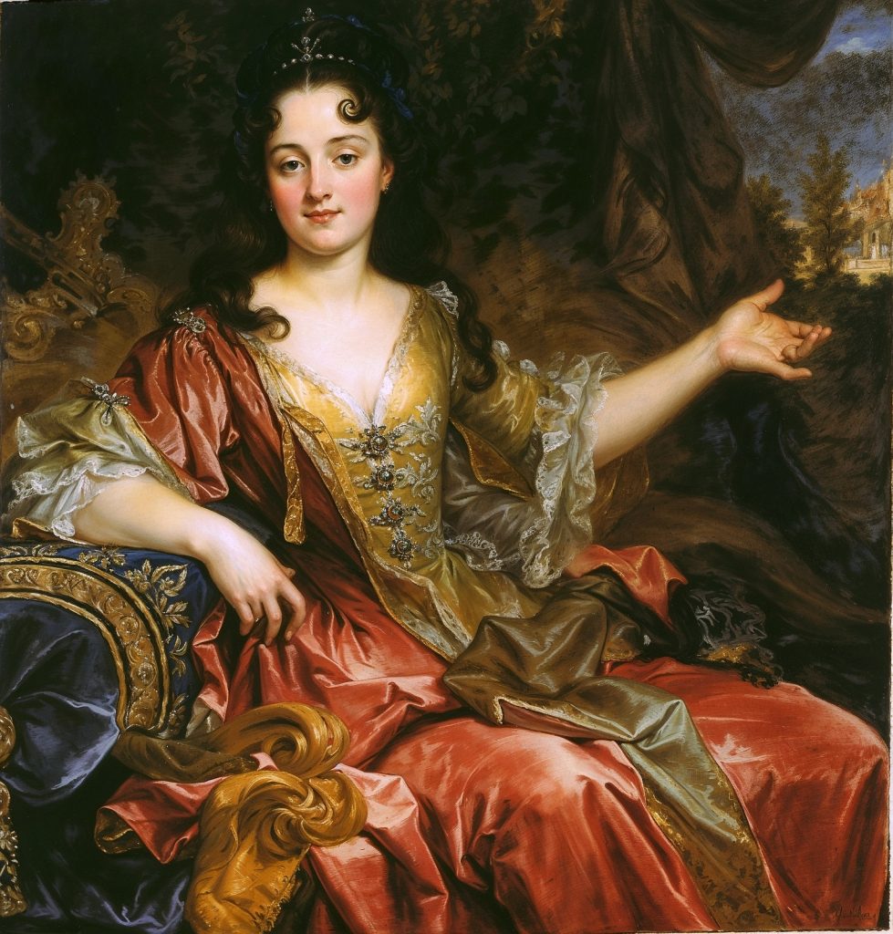 Retrato de la princesa Nerola, vestida con un elegante vestido rojo y dorado, sentada en un sillón ornamentado. La princesa muestra una expresión serena, con una mano extendida señalando hacia un paisaje en el fondo. La imagen ha sido mejorada digitalmente utilizando inteligencia artificial.