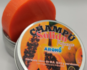 Champú sólido de Papaya de Aromú, pastilla naranja dentro de su envase metálico, ideal para nutrir el cabello con ingredientes naturales y sin químicos agresivos.