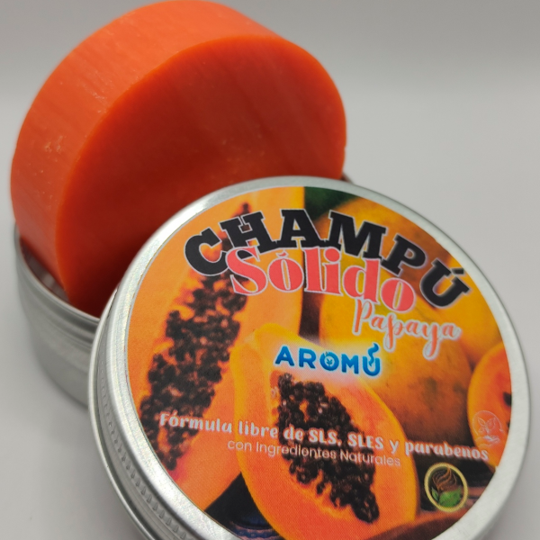 Champú sólido de Papaya de Aromú, pastilla naranja dentro de su envase metálico, ideal para nutrir el cabello con ingredientes naturales y sin químicos agresivos.
